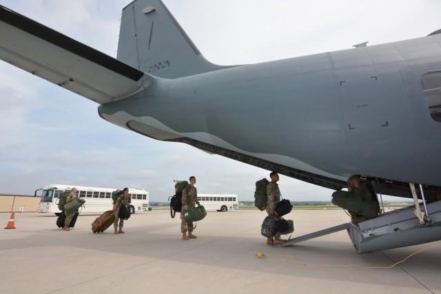 68W Combat Medic Soldiers maintain social distancing while boarding a U.S. Army C-27 aircraft. The Soldiers were transported in controlled air and ground movements to their next duty of assignment as an exception to the Department of Defense stop movement enacted to stop the potential spread of the 2019 Coronavirus Disease, or COVID-19.