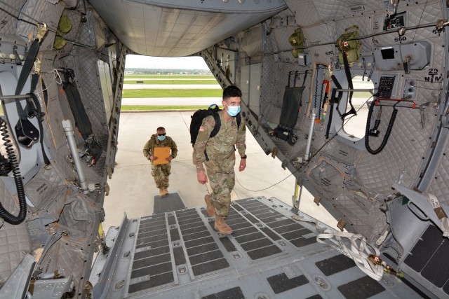 Wearing face masks and maintaining social distancing Soldiers board a U.S. Army C-27 aircraft. The Soldiers were transported in controlled air and ground movements to their next duty of assignment as an exception to the Department of Defense stop movement enacted to stop the potential spread of the 2019 Coronavirus Disease, or COVID-19.