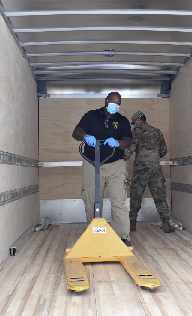 Sgt. 1st Class Michael Soles, Fort Jackson’s G5 non-commissioned officer in charge, and Supply Specialist Mark Hall load a pallet of travel kits April
6. The kits were donated to Fort Jackson trainees and activated South Carolina National Guards units by the South Carolina USO. 'We are paying it
forward to the men and women that need it most,' said Joanie Thresher, executive director of the South Carolina USO.