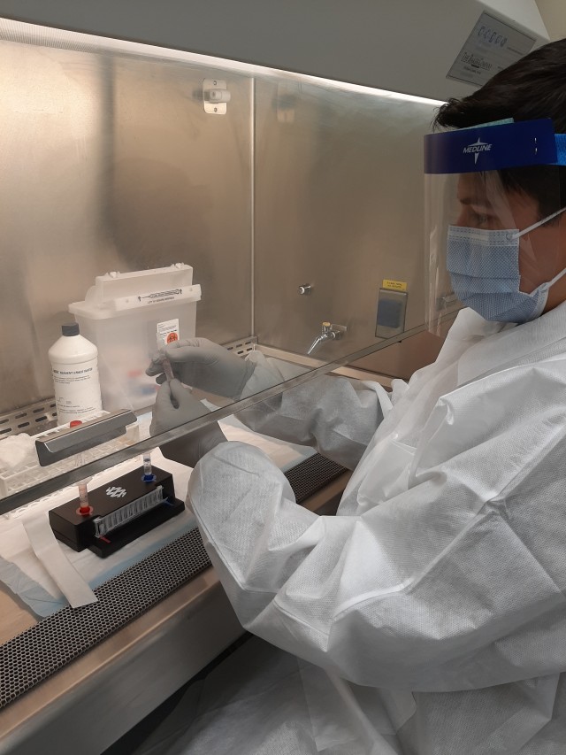 U.S. Army Sgt. Josue Caballero, noncommissioned officer in charge of the Vicenza Army Health Clinic laboratory, prepares specimen collections for the new COVID-19 rapid testing system. The Vicenza Clinic is one of three Army military medical treatment facilities to receive the new equipment, which is capable of providing COVID-19 test results in about one hour.