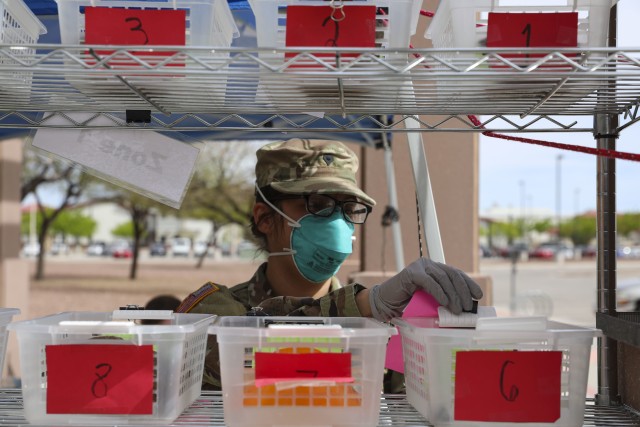 A U.S. Army Pharmacy Specialist prepares to dispense patient’s prescriptions at the William Beaumont Army Medical Center (WBAMC) curbside pharmacy service on Fort Bliss, Texas, April 6, 2020. WBAMC has implemented the new curbside pharmacy service as an additional health protection measure to help mitigate the spread of COVID-19, enabling Fort Bliss to better preserve the health and well-being of beneficiaries, staff and the El Paso community. (U.S. Army photo by: Staff Sgt. Michael L. K. West)