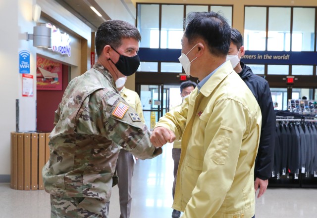 Eighth Army deputy commanding general for operations, Maj. Gen. Patrick Donahoe, and Pyeongtaek City mayor Jung Jang-seon, tap elbows to greet each other at the Humphreys Exchange, April 9. The mayor also visited the Brian D. Allgood Army Community Hospital tertiary tent, intensive care unit, testing lab and the Humphreys Commissary, to get a firsthand view of all the precautionary measures that have been put in place to mitigate the spread of coronavirus. (U.S. Army photo by Pfc. Jillian Hix, 20th Public Affairs Detachment)