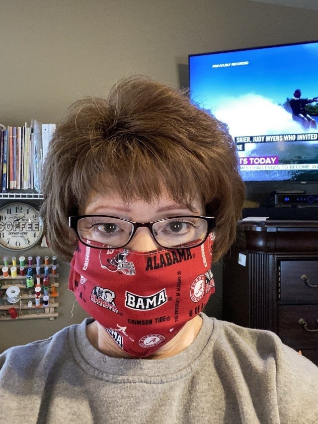 AMCOM Safety Officer Pat Vittitow models one of the face masks she made. Vittitow has donated masks to a children’s hospital, family members and her daughter’s co-workers.