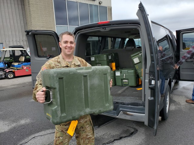 Chief Warrant Officer 3 Daniel Button is pictured handing off ventilators to the Georgia Air National Guard on April 3 following maintenance operations at Tobyhanna Army Depot. (U.S. Army photo by Tom Fortner)