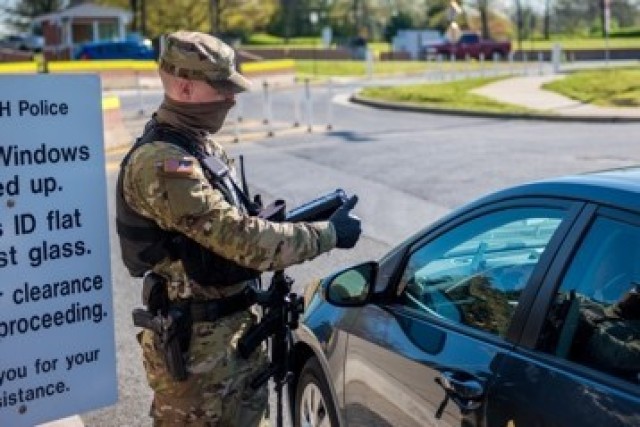 A Soldier with the 289th Military Police Company, 4th Battalion, 3d U.S. Infantry Regiment (The Old Guard), gives a driver a thumbs up after scanning their Common Access Card, on Joint Base Myer-Henderson Hall, Va., April 9, 2020. 