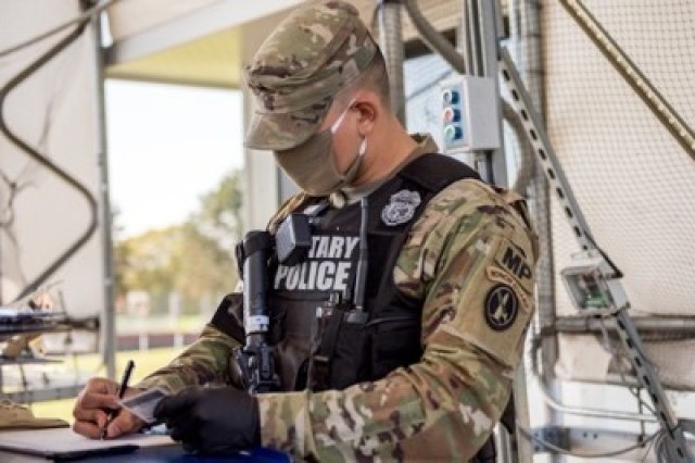A Soldier with the 289th Military Police Company, 4th Battalion, 3d U.S. Infantry Regiment (The Old Guard), logs a civilian visitor’s information, on Joint Base Myer-Henderson Hall, Va., April 9, 2020.
