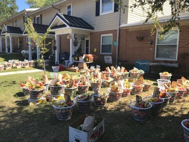 Rows of baskets filled with fresh fruits and vegetables sit outside a Fort Jackson on-post housing residence waiting to be picked up. Roughly 70 members of Fort Jackson Family Homes have banded together to purchase 1,500 lbs. of fresh produce from...