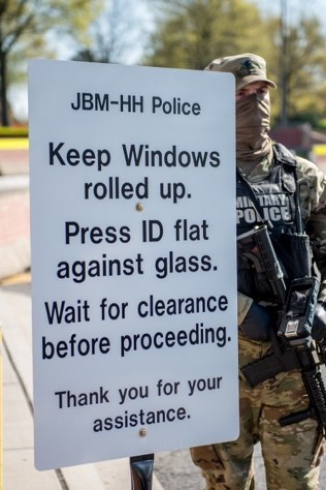 A sign outside of the Hatfield Gate, of Joint Base Myer-Henderson Hall, Va., states new policies in regard to COVID-19, April 9, 2020.