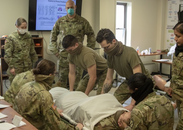 10th Mountain Division (LI) medics practice wrapping and moving a patient in a nurse clinical training day at Medical Simulation Training Center, Fort Drum, N.Y, on April 9th, 2020. The training day provided additional training for medics in areas they may not be familiar with, and to provide skills that are outside their scope of practice but may need to perform in an emergency situation.