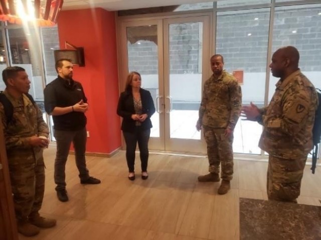 From right, Lt. Col. Jason Miles, Maj. Jermaine Pruitt and Master Sgt. Cirildo Guerrero Jr., explain the requirement for lodging to the staff at a New York City area hotel. Miles and Pruitt are deployed to New York City to provide contracting...