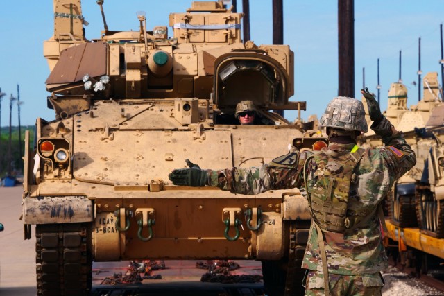 FORT HOOD, TX—Soldiers with 3rd Armored Brigade Combat Team, 1st Cavalry Division download a Bradley Fighting Vehicle to a rail car here April 1. The Soldiers conducted redeployment operations for the Brigade during the COVID-19 outbreak.
