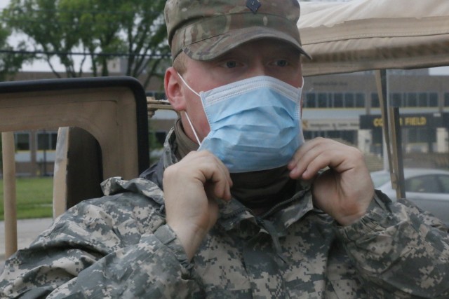 FORT HOOD, Tx--Spec. Mackenzie West, a member of Team Transport for C Co., 3rd Battalion, 8th Cavalry Regiment, 3rd Armored Brigade Combat Team, 1st Cavalry Division adjusts his protective face mask in preparations to transport a COVID-19 positive...