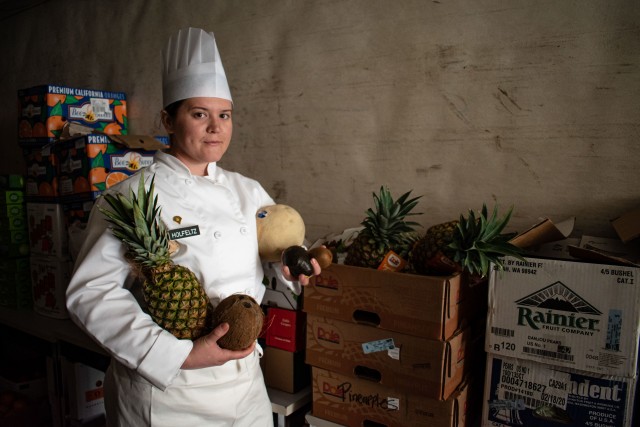 U.S. Army Spc. Alexis Holfeltz, a culinary specialist with 1158th Army Aviation Reserve Command, Conroe, Texas, poses for a portrait on a Mobile Kitchen Trailer for the Joint Culinary Training Exercise March 7, 2020.  The 45th annual JCTE started March 4 at Fort Lee MacLaughlin Fitness Center and continues until March 13.  The exercise, administered by the Joint Culinary Center of Excellence, is the largest American Culinary Federation-sanctioned competition in North America. The exercise showcased the talent of more than 200 military chefs from all military services around the globe to include four international teams.  