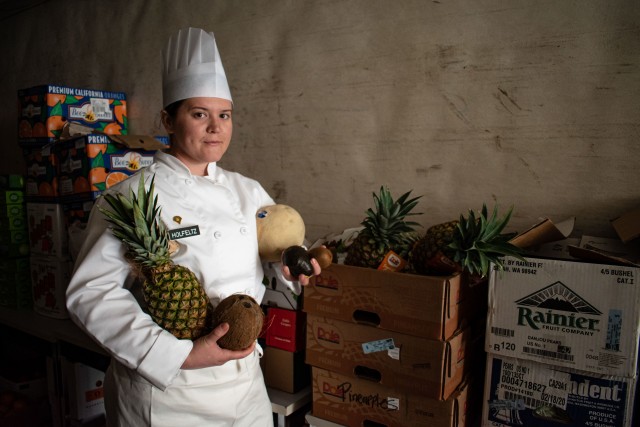 U.S. Army Spc. Alexis Holfeltz, a culinary specialist with 1158th Army Aviation Reserve Command, Conroe, Texas, poses for a portrait on a Mobile Kitchen Trailer for the Joint Culinary Training Exercise March 7, 2020. The 45th annual JCTE started...