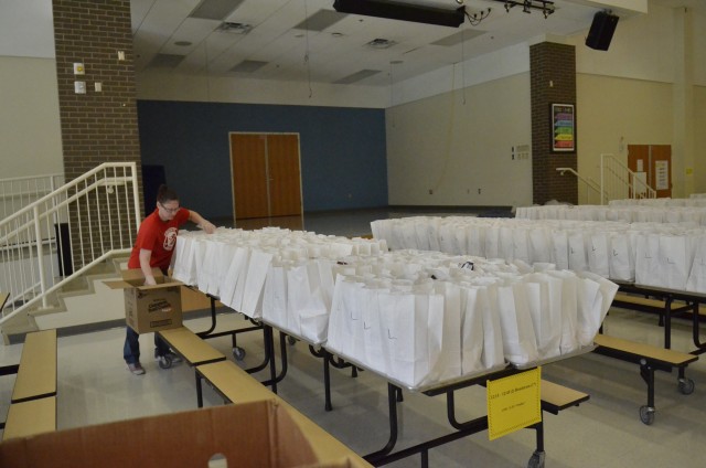 Brandi Saunto, Barsanti Elementary School Parent Teacher Organization president, helps package free grab-and-go breakfast and lunch meals for children age 18 and younger at Barsanti Elementary School, Fort Campbell.