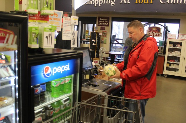 Harry Hughes with the Installation Legal Office at Fort McCoy, Wis., uses a self checkout April 3, 2020, at the Fort McCoy Commissary. Since the installation’s response to the COVID-19 pandemic began in March 2020, the Fort McCoy Commissary...