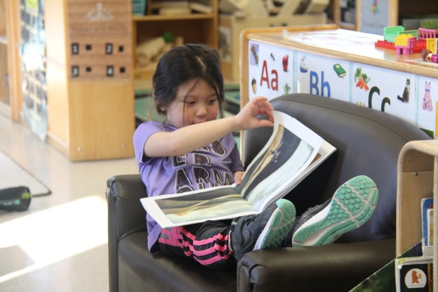 A Students at the Child Development Center (CDC) reads a book March 17, 2020, at Fort McCoy, Wis. The CDC is Department of Defense certified and nationally accredited. (U.S. Army photo by Aimee Malone, Public Affairs Office, Fort McCoy, Wis.)