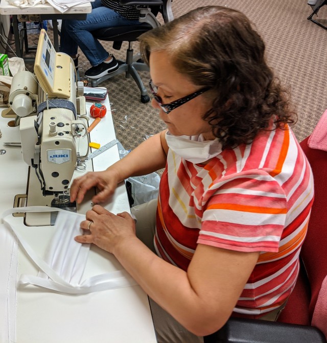 Nilda Otero, a volunteer at the sewing facility, assembles a protective face mask for use by the West Point community.