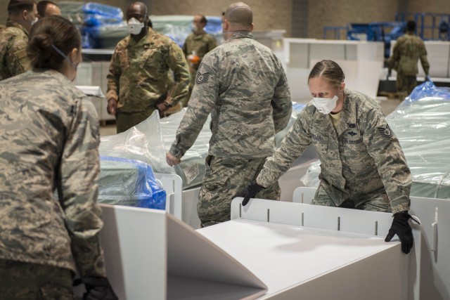 Soldiers and Airmen from the Connecticut National Guard set up field hospital beds at the Connecticut Convention Center in Hartford, Conn., April 11, 2020. The site will contain over 600 beds and serve as potential hospital surge capacity for...