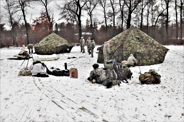 Fort McCoy Cold-Weather Operations Course (CWOC) Class 20-05 students set up an Arctic 10-person tent March 20, 2020, at a South Post training area at Fort McCoy, Wis. CWOC students are trained on a variety of cold-weather subjects, including...
