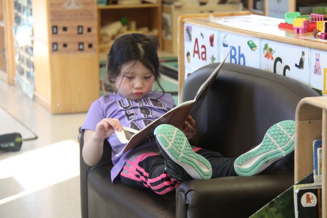 A Students at the Child Development Center (CDC) reads a book March 17, 2020, at Fort McCoy, Wis. The CDC is Department of Defense certified and nationally accredited. (U.S. Army photo by Aimee Malone, Public Affairs Office, Fort McCoy, Wis.)