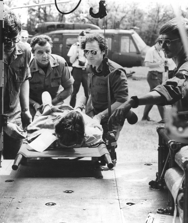 Members of the 830th Station Hospital, 88th Army Reserve Command, of Des Moines, Iowa, load a mock casualty into a helicopter during mock mass casualty training in 1970 at then-Camp McCoy. (U.S. Army file photo)