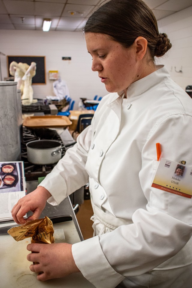 U.S. Army Spc. Alexis Holfeltz, a culinary specialist with 1158th Army Aviation Reserve Command, Conroe, Texas, unwraps a block of butter to create desserts in the Joint Culinary Training Exercise March 7, 2020.  The 45th annual JCTE started March 4 at Fort Lee MacLaughlin Fitness Center and continues until March 13.  The exercise, administered by the Joint Culinary Center of Excellence, is the largest American Culinary Federation-sanctioned competition in North America. The exercise showcased the talent of more than 200 military chefs from all military services around the globe to include four international teams. 