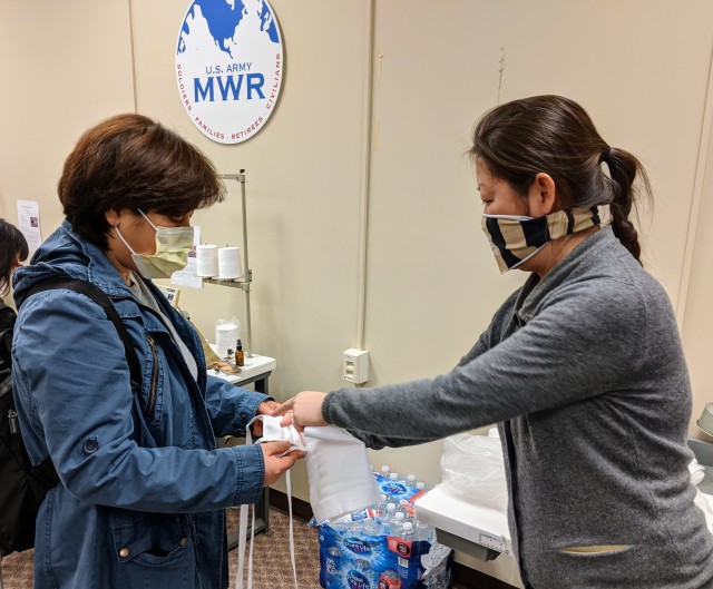 Jia Liu (right), the volunteer manager of the sewing facility, explains how to construct a mask to Hongran Conrad, a volunteer at the site. (Photos by Dave Conrad/Garrison West Point PAO)