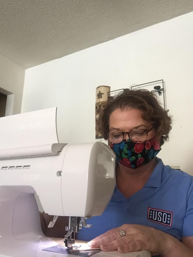 Ellie Hazlett with USO Wisconsin sews cloth face masks at her home April 11, 2020, in Sparta, Wis. Hazlett delivered 50 cloth masks she made to Fort McCoy, Wis, on April 13. The support is part of USO Wisconsin's effort to help during the COVID-19 pandemic response statewide. Hazlett makes masks as part of a USO Wisconsin sewing team that is making masks for service members around the state. (Courtesy photo)