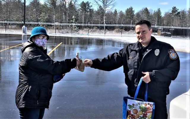 Ellie Hazlett with USO Wisconsin delivers 50 cloth face masks April 13, 2020, to Lt. Benjamin Finn with the Directorate of Emergency Services Police Department at Fort McCoy, Wis. The support is part of USO Wisconsin's effort to help during the...