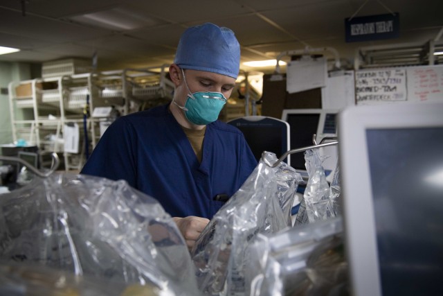 U.S. Navy Hospital Corpsman 3rd Class James Abbe preps a dialysis machine aboard the Military Sealift Command hospital ship USNS Comfort (T-AH 20). Comfort cares for trauma, emergency and urgent care patients without regard to their COVID-19...