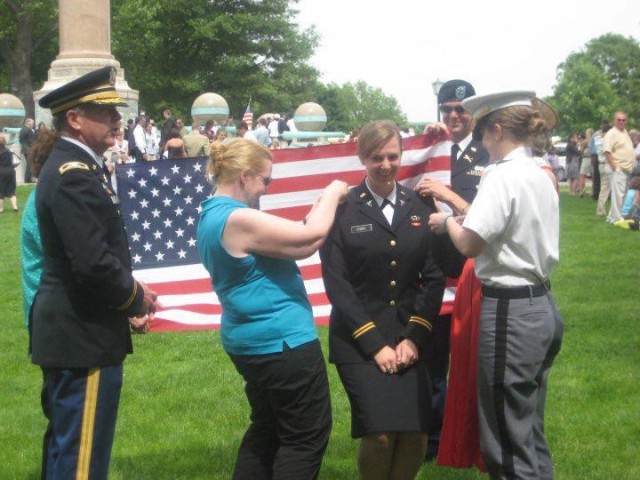 Then 2nd Lt. Elyse Pierre (Fiore) poses as members of her family surround her and affix decorations to her uniform shortly after she received her commission as a medical officer in the Army in 2010. Although each member of the Fiore family has taken their own distinct path in their service, father Uldric as a retired member off the Senior Executive Services and retired Judge Advocate General Colonel, mother Nancy Colfax as a retired lawyer and dedicated Army spouse, and siblings Nicholas, Carolyn and Elyse as armor, aviation and medical officers, respectively, their continued dedication to service and their unique circumstances has brought them together and strengthened them as a family. (Courtesy photo)