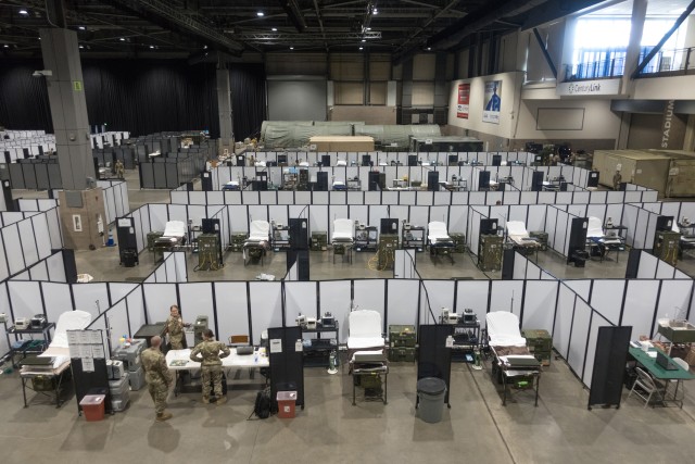 Soldiers from the 627th Army Hospital based in Fort Carson, Colo., work to set up a field hospital in the Centurylink Field Events Center in Seattle April 5, 2020. Today, U.S. Army North has over 9,000 personnel assisting local and state governments against the virus, while serving as the Joint Forces Land Component Command under U.S. Northern Command. 