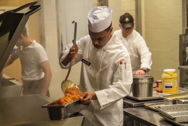 Pfc. Bernard Jackson, culinary specialist, Forward Support Company, 1st Squadron, 32nd Cavalry, 1st Brigade Combat Team “Bastogne”, 101st Airborne Division preparing sweet potatoes for the lunch meal served on April 2 in the Snipes Dining Facility on Fort Campbell, Kentucky. The Snipes Dining Facility is remaining open seven days a week to ensure Bastogne Soldiers safely receive a healthy meal to sustain their physical and mental readiness during their response to COVID-19. U.S. Army photo by Maj. Vonnie Wright.