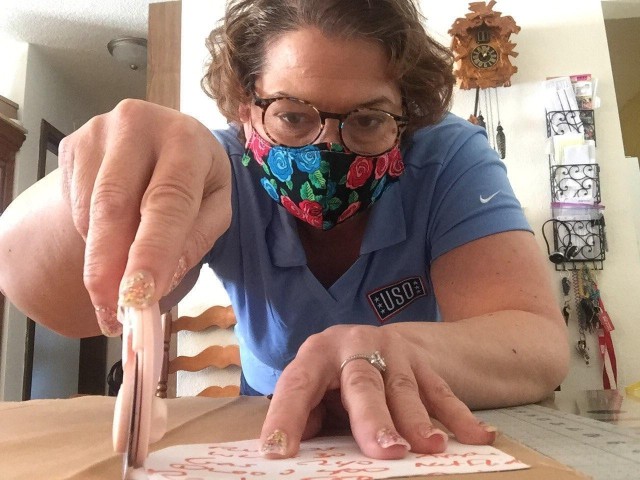 Ellie Hazlett with USO Wisconsin sews cloth face masks at her home April 11, 2020, in Sparta, Wis. Hazlett delivered 50 cloth masks she made to Fort McCoy, Wis, on April 13. The support is part of USO Wisconsin's effort to help during the COVID-19 pandemic response statewide. Hazlett makes masks as part of a USO Wisconsin sewing team that is making masks for service members around the state. (Courtesy photo)