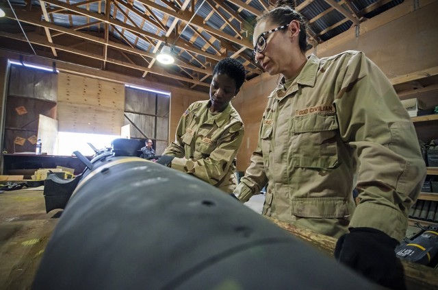 Jennifer Voelkelt (right), quality assurance specialist, ammunition surveillance, Army Field Support Battalion-Afghanistan, and Christabel Frazier (left), QASAS, AFSBn-AFG examine a Hellfire Missile during an inspection at Bagram Airfield,...