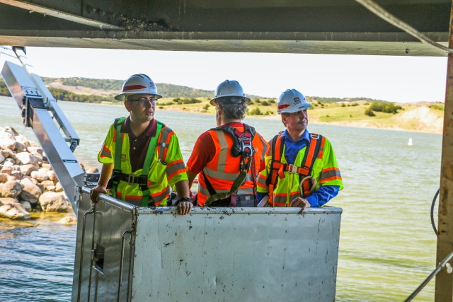 Narturi Narisco, left, and Lyle Peterson, civil engineers, U.S. Army Corps of Engineers, Omaha District, hang above the Missouri River in a snooper Sept. 23, 2019, to inspect the underside of one of the bridges at the Big Bend Dam near Fort...
