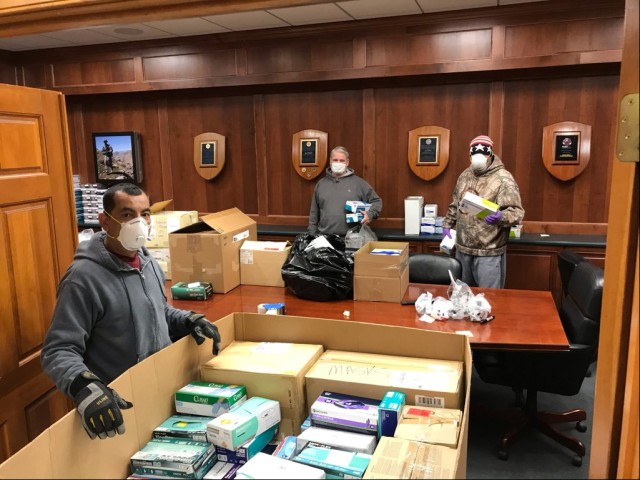 U.S. Army Combat Capabilities Development Command Soldier Center employees David Garcia (left), Matt Daly (center), and James Cahoon (right) pack medical personal protective equipment in Natick, Mass., for delivery to the Army’s 44th Medical...