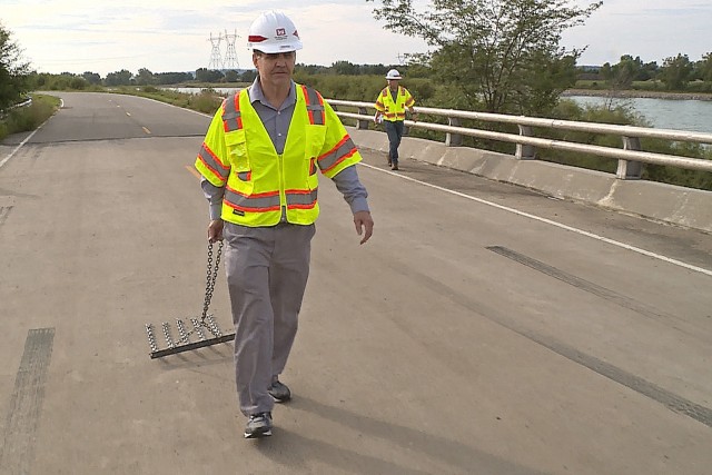 Lyle Peterson, civil engineer, U.S. Army Corps of Engineers, Omaha District, drags a chain across one of the bridges at the Big Bend Dam near Fort Thompson, S.D., Sept. 23, 2019. Chaining allows bridge inspectors to determine whether or not there...