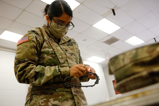 Spc. Melissa Luna, a information technology specialist with the 18th Field Artillery Brigade,  finishes assembling a face shield at Fort Bragg, N.C., on April 15, as part of Operation Dragon Mask. Units from across Fort Bragg were repurposed to...