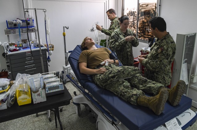 Staff from the Expeditionary Medical Facility (EMF), demonstrate medical equipment used to stabilize patients at the COVID-19 Intensive Care Unit (ICU) facility at Camp Lemonnier, Djibouti, April 9, 2020. The COVID-19 ICU is located separately from the EMF to prevent potential cross-contamination of the virus. (U.S. Air Force photo by Senior Airman Kristen A. Heller)