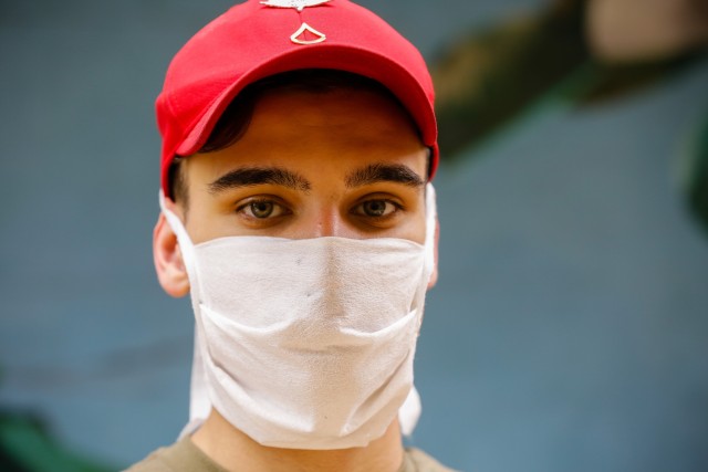 Pfc. Joshua Auman, a parachute rigger with the 647th Quarter Master Company, 3rd Expeditionary Sustainment Command, after making protective masks at Fort Bragg, N.C., on April 15, as part of Operation Dragon Mask. Units from across Fort Bragg were...