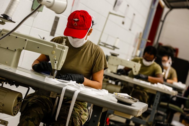 Pfc. Rosi Veldez, a parachute rigger with the 647th Quarter Master Company, 3rd Expeditionary Sustainment Command, sews protective masks at Fort Bragg, N.C., on April 15, as part of Operation Dragon Mask. Units from across Fort Bragg were repurposed to create face masks, face shields, and other personal protective equipment to be distributed as part of the COVID-19 response. (U.S. Army Photo by Spc. Hubert D. Delany III)