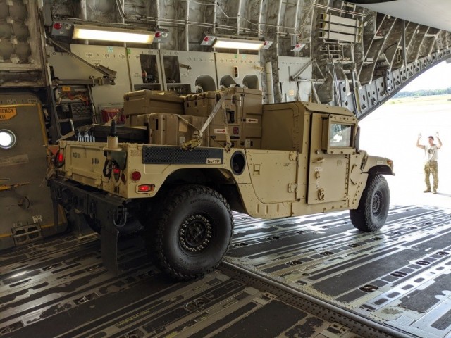 A Soldier from A Company, 63rd Expeditionary Signal Battalion, 35th Signal Brigade assigned to Fort Stewart, Ga. move their High Mobility Multipurpose Wheeled Vehicle (HMMWV) loaded with communication equipment on a plane at Hunter Army Airfield, April 4, 2020. The 63rd ESB is moving personnel and equipment in support of U.S. Northern Command and U.S. Army North’s request for defense support of civil authorities in response to the COVID-19 pandemic by providing communications support to areas affected by COVID-19. 