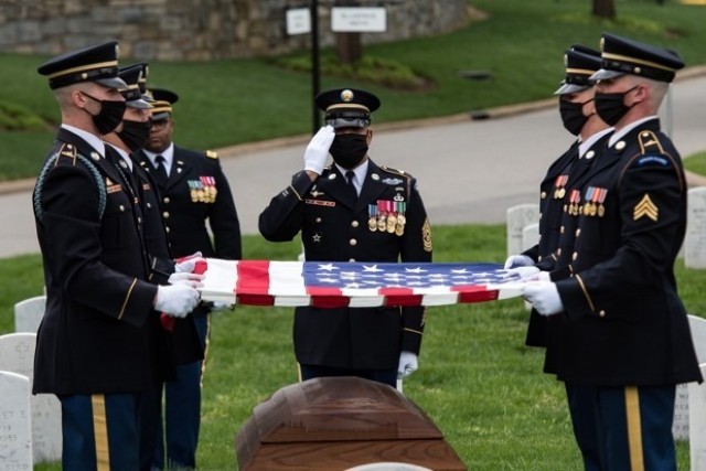 Soldiers assigned to 1st Battalion, 3d U.S. Infantry Regiment (The Old Guard) conduct military funeral honors for U.S. Army Retired Command Sgt. Maj. Robert M. Belch in Section 68 of Arlington National Cemetery, Arlington, Virginia, April 14, 2020. Given current health protection guidance from the Secretary of Defense, Old Guard Soldiers wear face coverings to mitigate the spread of COVID-19 while executing the Memorial Affairs mission.