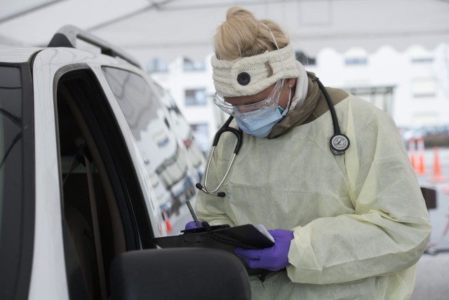 U.S. Air Force Staff Sgt. Maxime Copley, 86th Medical Group independent duty medical technician, writes down patient information in the Ramstein Medical Clinic’s coronavirus disease 2019 screening drive-thru at Ramstein Air Base, Germany, March...