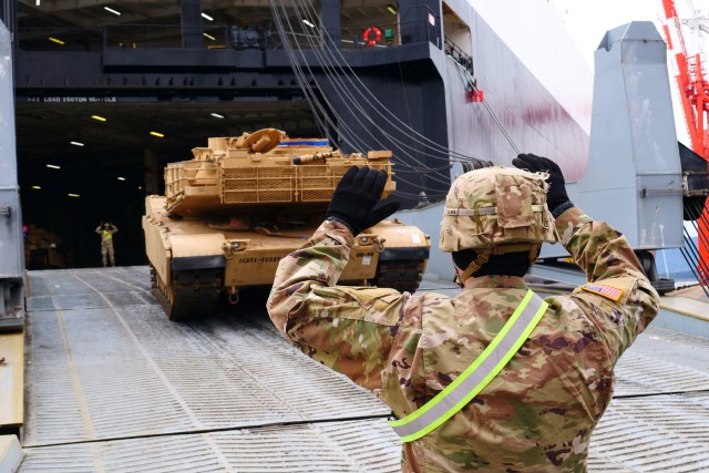 Soldiers with 3rd Brigade Combat Team, 1st Cavalry Division and 2nd Brigade Combat Team, 1st Infantry Division ground guide a 3rd Brigade tank onto a ship here February 29. The Soldiers conducted redeployment operations for the Brigade during the...