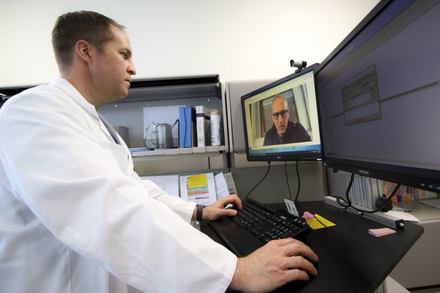 U.S. Air Force Lt. Col. Brendt Feldt, a surgeon at Landstuhl Regional Medical Center’s Ear, Nose and Throat Clinic, conducts a virtual health appointment via synchronous video, April 7. Virtual Health utilization has increased more than five times during COVID-19 operations at LRMC, allowing patients, providers and support staff to continue delivering high-quality patient care virtually while following recommended physical distancing measures to minimize contact. (Marcy Sanchez)