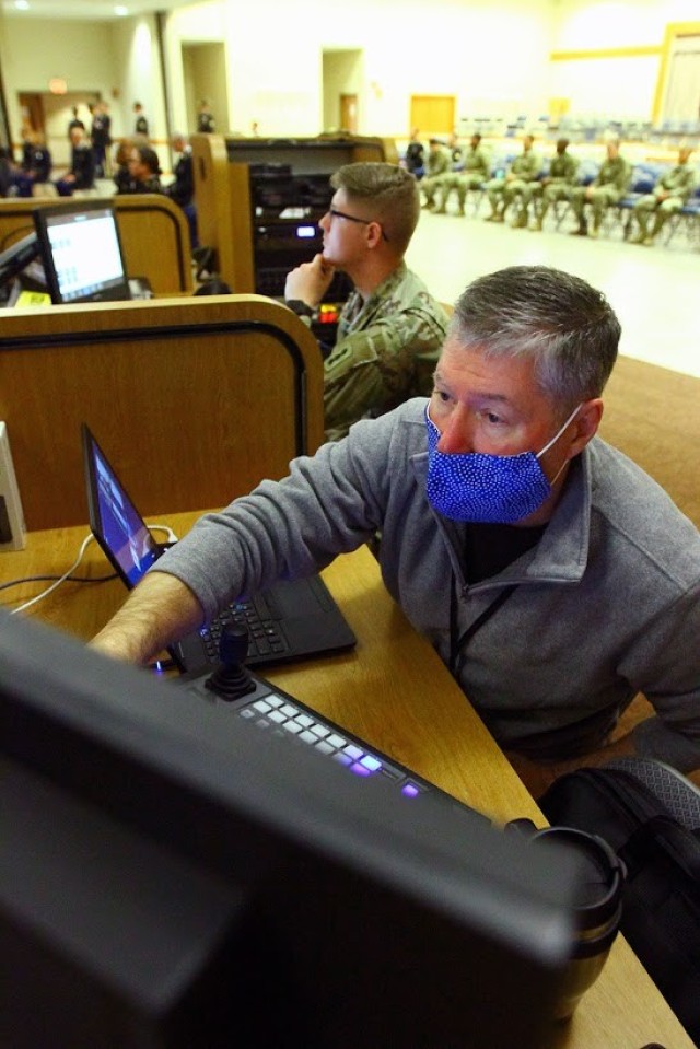 Dave Johnson, FCoE G6 livestream manager, and Spc. Austin Wilson, 1-31 FA religious affairs specialist, monitor the livestream graduation April 17, 2020,  at Cache Creek Chapel.