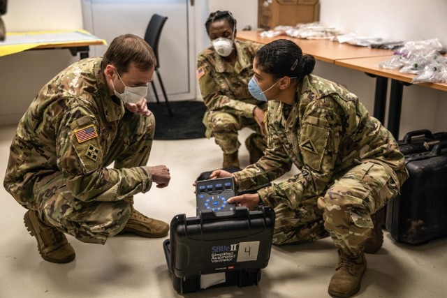 Lt. Col. Preston, Commander of the US Army Health Clinic in Hohenfels, inspects mobile ventilators at the Pete Burke Center on Artillery Barracks in Garmisch-Partenkirchen, Germany, April 15. The Burke Center has been transformed from Garmisch’s...